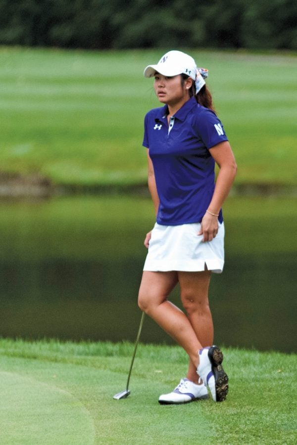 A Northwestern golfer prepares her next shot. The Wildcats fell one stroke shy of advancing in the NCAA Tournament.