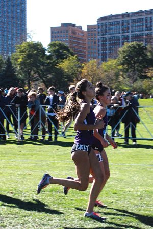Two Northwestern runners compete in a race. The Wildcats will run in nearby Naperville, Illinois a few weeks after racing in Champaign. 