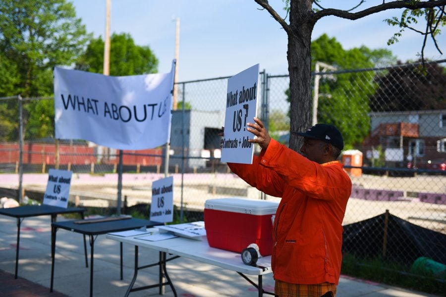 A protestor holds a sign asking “What about Us?” during a protest over Youth & Opportunity United contracting for construction of its new center at 1911 Church St. Organizers said the protest aimed to showcase community concern over lack of employment opportunities for local minority workers.