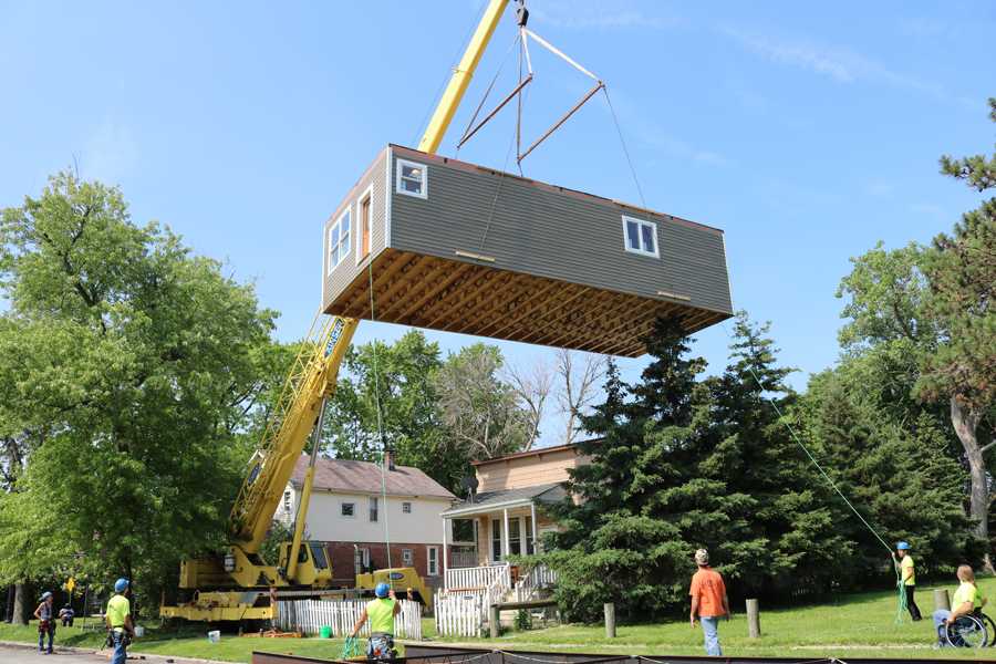 Construction+workers+lift+and+transport+the+first+floor+of+the+home+built+by+students+in+the+Evanston+Township+High+School+course%2C+Geometry+in+Construction.+The+entire+home+was+two-stories+and+approximately+1%2C500+square-feet.