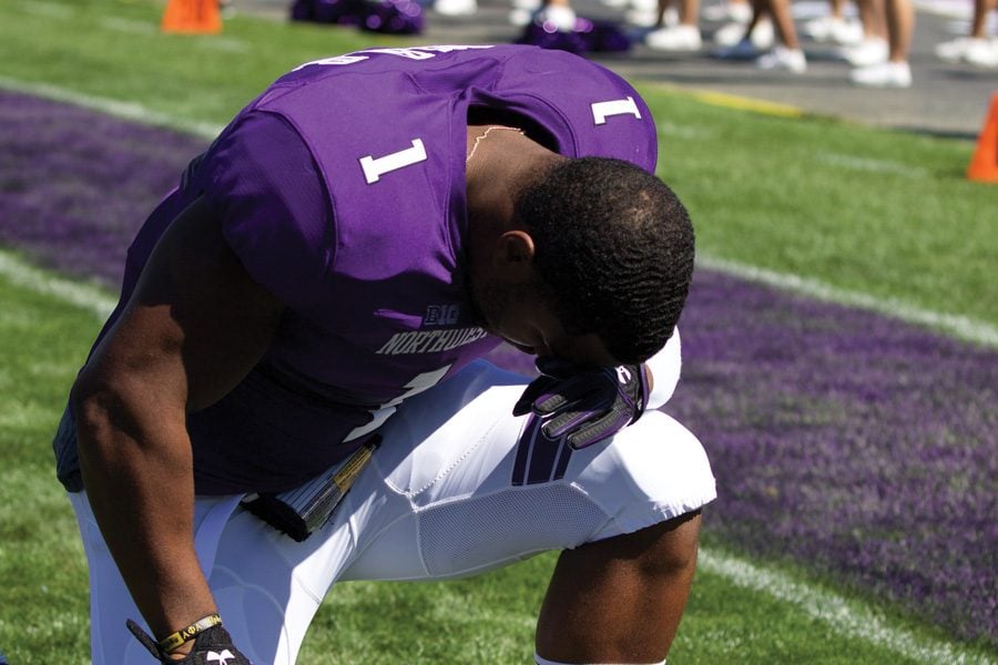 Anthony Walker kneels before a game. The junior linebacker is averaging under six tackles per game so far this season. 