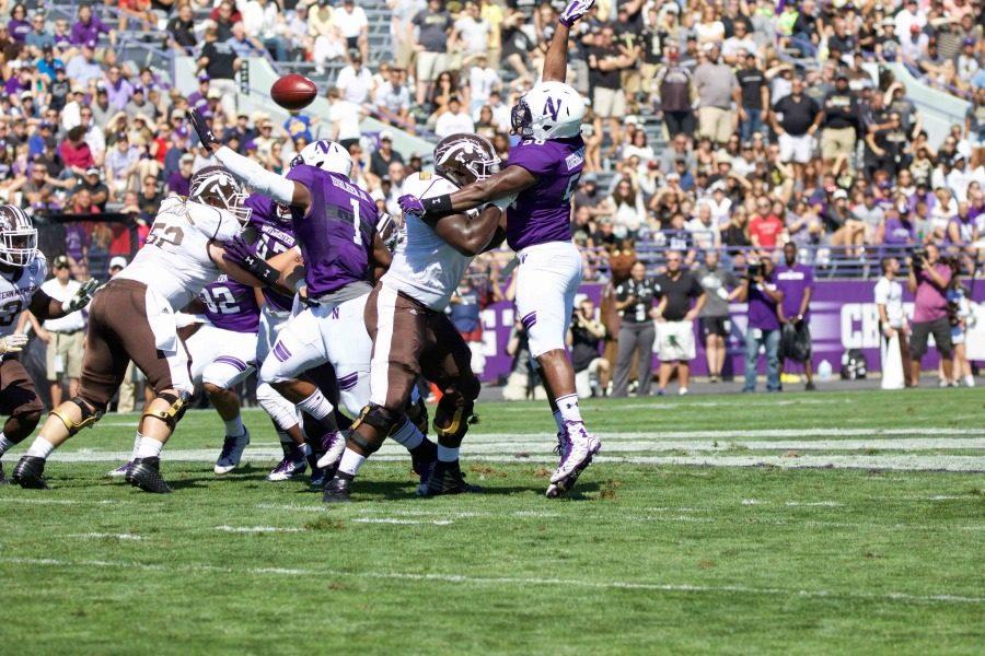 Xavier Washington tries to swat a pass. The junior defensive end has had five tackles through Northwesterns first two games.