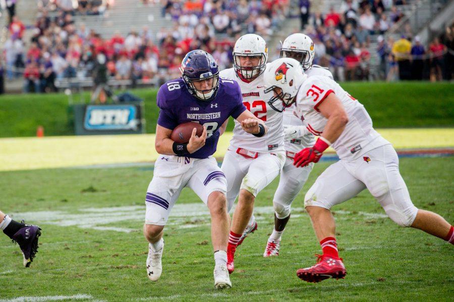Clayton Thorson prepares to take a hit from Illinois State defenders. The sophomore quarterback completed just 17-of-41 pass attempts in the Wildcats 9-7 loss.