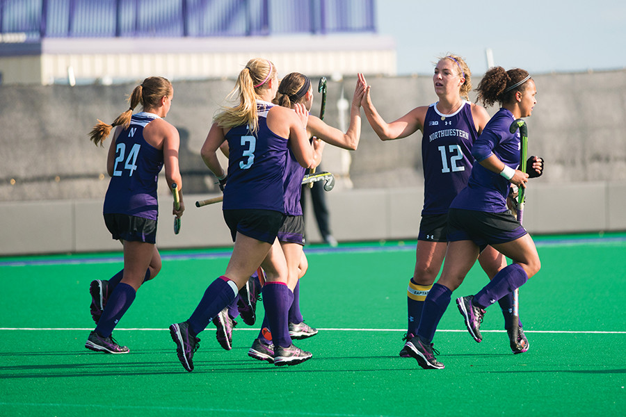 A group of Wildcats celebrate. Northwestern earned a late upset against No. 8 Boston College on Friday but failed to edge No. 4 Duke on Sunday.