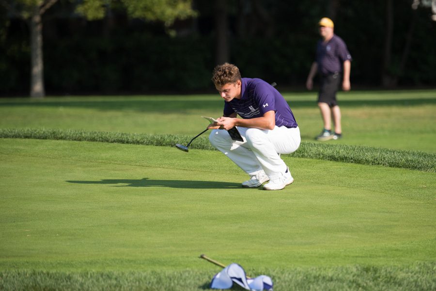 Ryan Lumsden consults his yardage book. The sophomore helped Northwestern to a decisive win over Army in the Bush Cup. 