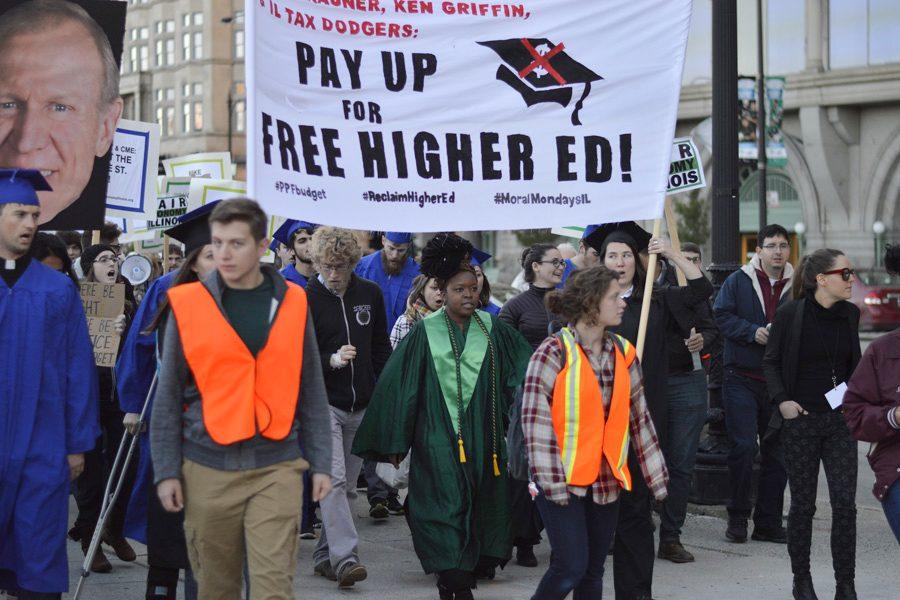 Weinberg senior Jackson Paller (center) helps lead a group of protesters during a demonstration for affordable higher education in Illinois. Hundreds of people gathered for the event, including students from Student Action NU.