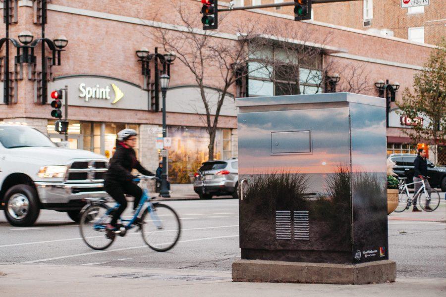 A utility box outside of Barnes and Noble, 1630 Sherman Ave., has been decorated with a vinyl photograph of a sunrise on Lake Michigan. The redecoration is part of an effort by an Evanston high school student to beautify the city. 
