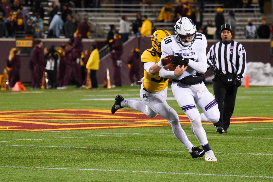 Clayton Thorson tries to evade a defender. The sophomore quarterback fumbled twice in Northwesterns loss to Minnesota.
