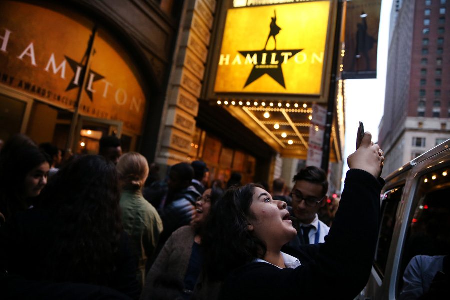 Diana Andrade, 17, takes a photograph outside the PrivateBank Theatre where Hamilton is making its Chicago premiere on Wednesday, Oct. 19, 2016 in Chicago. Andrade was among a group of students from Chicago Hope Academy who were attending the premiere. Northwestern will offer two courses on Hamilton during Winter Quarter.