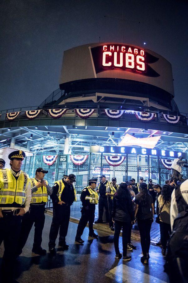 Police stand outside Wrigley Field on Wednesday night. Three Northwestern students say police grabbed them from the crowd near the stadium just before the Cubs won the World Series.