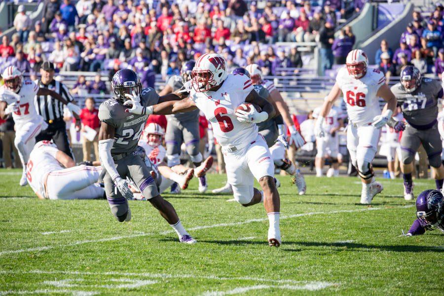 Wisconsin running back Corey Clement stiff arms sophomore cornerback Montre Hartage. Clement tallied 106 yards on the ground Saturday.