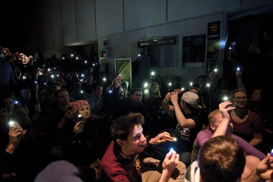 Students and faculty raise lights at the Virginia Wadsworth Wirtz Center for the Performing Arts on Thursday as part of the nationwide Ghostlight Project. The movement aims to demonstrate the role theater has in providing a safe space in the face of oppression.
