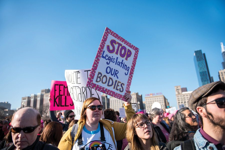 (Katie Pach/Daily Senior Staffer) Protesters hold up signs at the Women’s March on Chicago. An estimated 250,000 people attended the march, far exceeding the expected number of marchers.