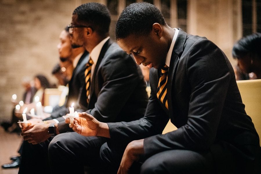 Brothers of Alpha Phi Alpha sit in silence as they hold their candles to honor the legacy of Martin Luther King, Jr. The event was held as part of a two-week long series to reflect on King’s lessons as a community.