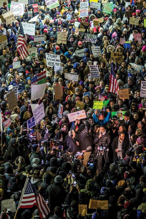 Demonstrators gather Sunday outside Terminal 5 of OHare International Airport to protest President Donald Trump’s executive order on immigrants and refugees. Over the weekend, about 150 attorneys and at least 1,000 protesters gathered at the airport to help detainees gain entry.