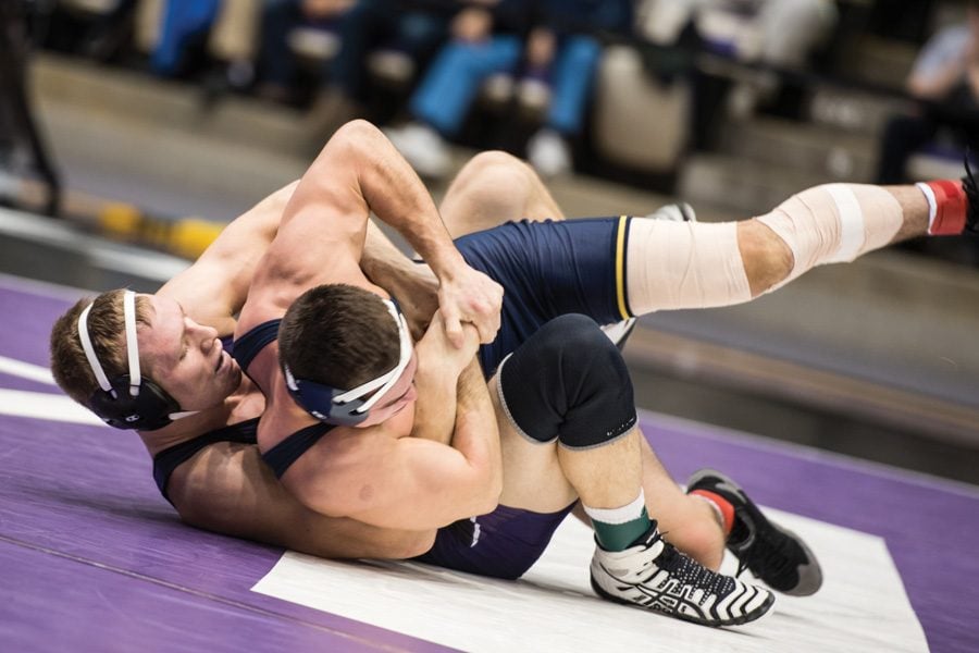 Mitch Sliga wrestles an opponent on the mat. The junior’s victory was among the few bright spots in Northwestern’s loss to Michigan.