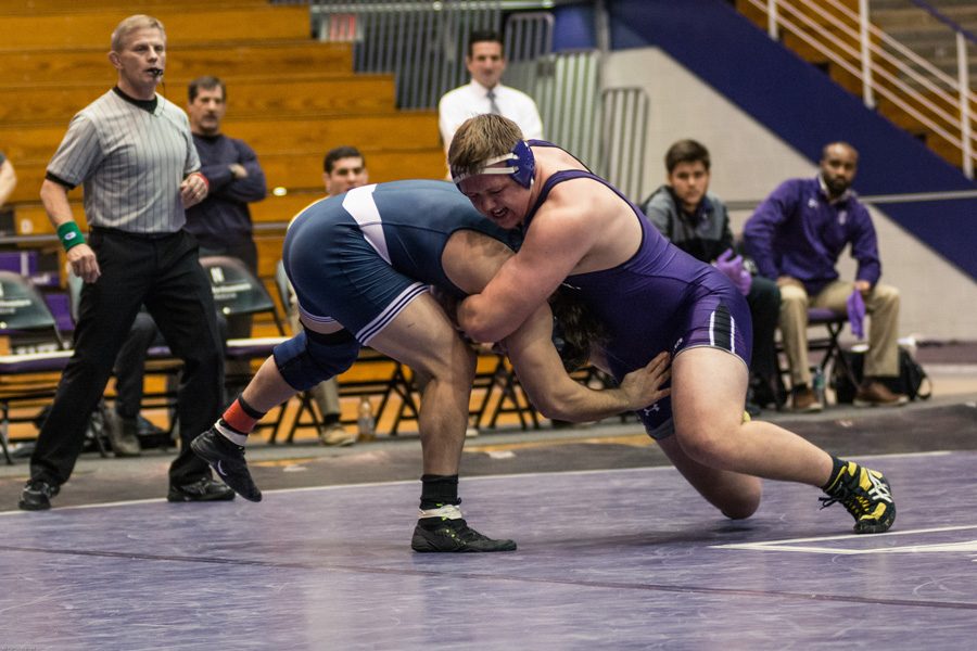 Conan Jennings wrestles an opponent. The sophomore heavyweight secured Northwestern’s comeback against Michigan State on Friday.