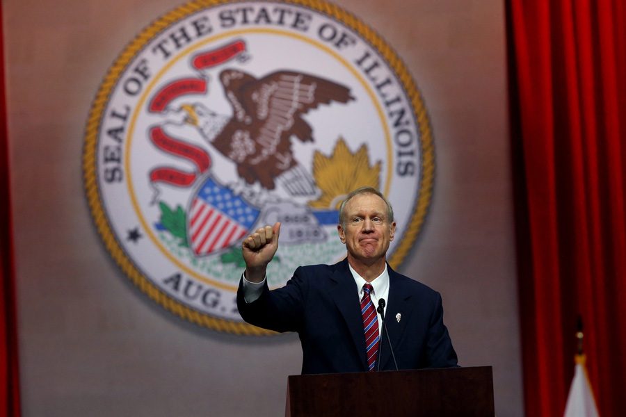 Gov. Bruce Rauner speaks at an event. Rauner said during his annual budget address urged state senators to consider a permanent property tax freeze to go along with a proposed permanent increase in the state income tax.