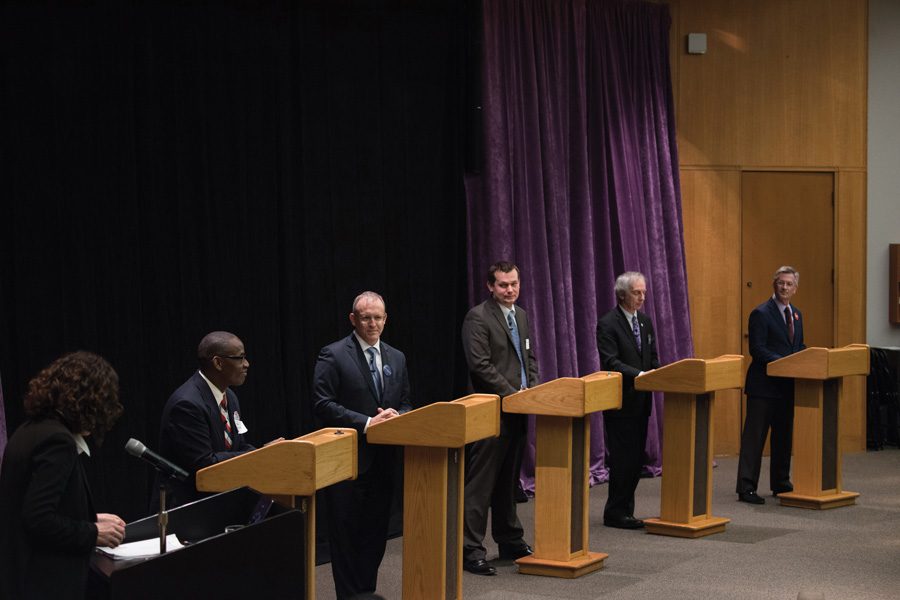 The five mayoral candidates stand on stage at a forum hosted by Northwestern Thursday evening. The candidates emphasized the importance of keeping town-gown relations intact. 