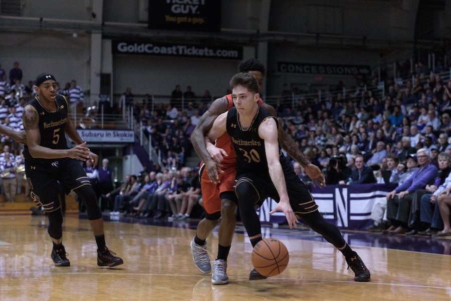 Bryant McIntosh drives past a defender. The junior guard led Northwestern with 16 points against Illinois. 