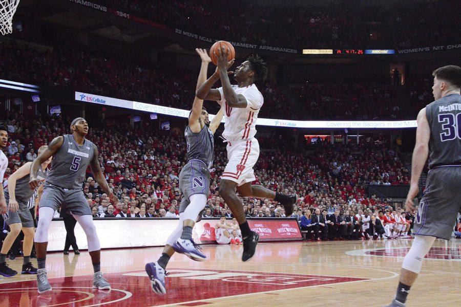 Sanjay+Lumpkin+defends+a+shot.+The+senior+forward+and+the+Wildcats+helped+solidify+their+NCAA+Tournament+resume+with+Sunday%E2%80%99s+win+at+No.+7+Wisconsin.