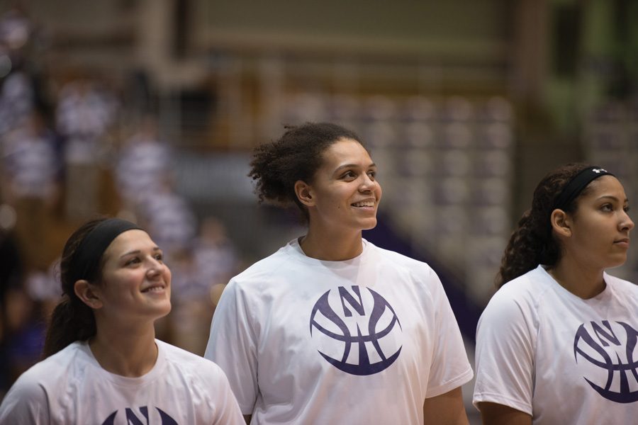 Oceana Hamilton smiles alongside her teammates. The junior center gave Northwestern a boost on the boards, though the team struggled overall to rebound against Iowa.