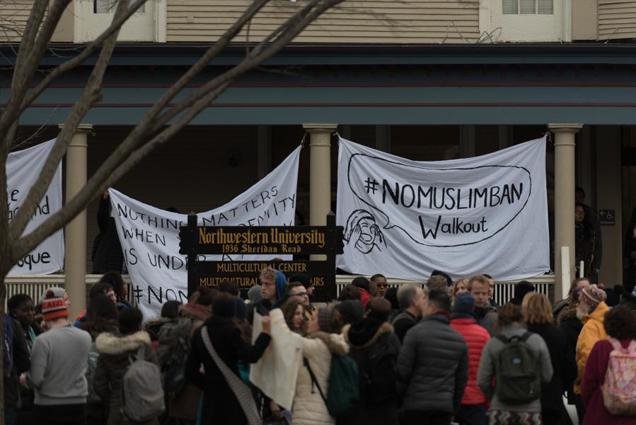 Protesters gather outside the Multicultural Center on Wednesday to demonstrate against President Trump’s recent immigration action. The event, titled #NoMuslimBan Walkout, was organized by Immigrant Justice Project and various other groups on campus.