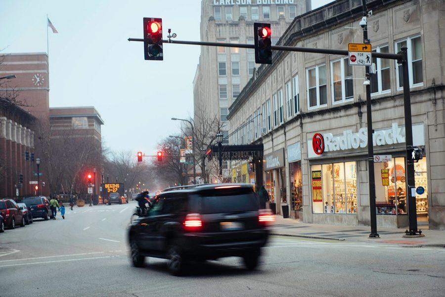 A car runs a red light on the intersection of Sherman Ave. and Church St. Chicago will be relocating six red light cameras and increasing the grace period for running a red light in response to a study held by the Northwestern Transportation Center.