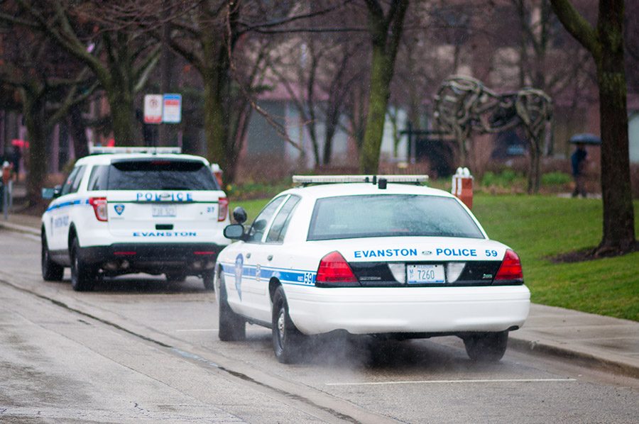 Two parked Evanston police cars. On Wednesday, a man filed a lawsuit after allegedly being hit by a vehicle that was being pursued by Evanston police officers. 