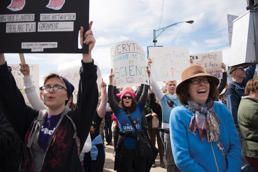 Protesters hold up signs during the March for Science Chicago on Saturday. Organizers estimated that roughly 50,000 people participated in the march.