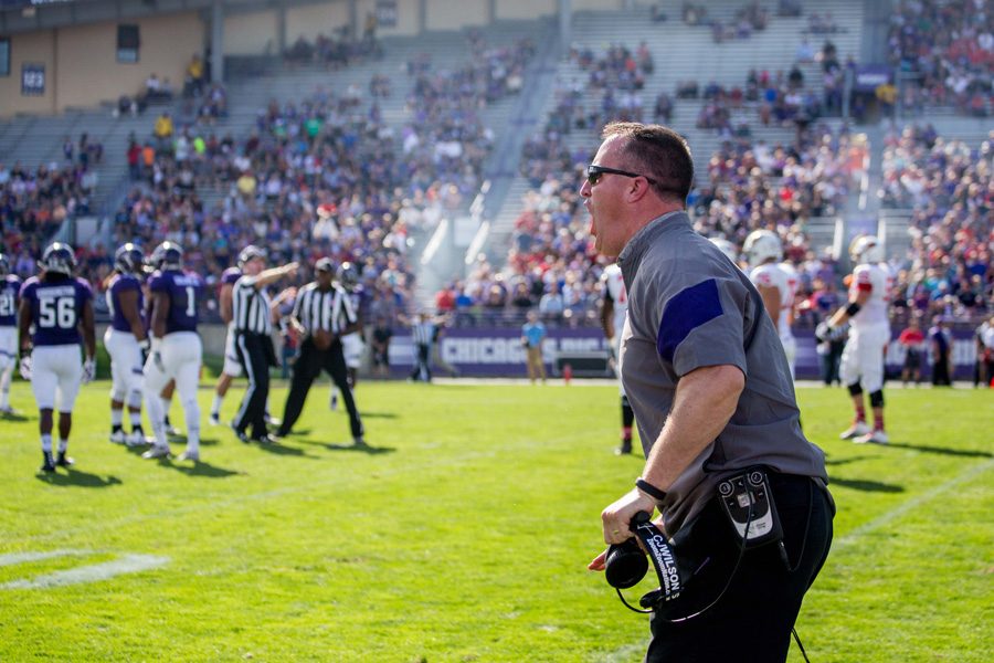 Football coach Pat Fitzgerald yells during a game. Fitzgerald and men’s basketball coach Chris Collins received contract extensions on Monday, according to reports.