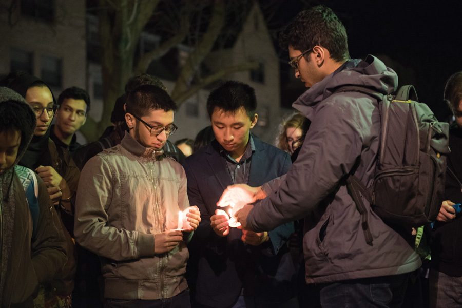 Students light candles outside of Lutkin Hall in memory of first-year student Mohammed Ramzan. Ramzan passed away Monday during crew practice. 