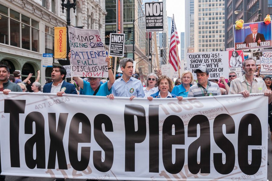 State Sen. Daniel Biss (D-Evanston) and U.S. Rep. Jan Schakowsky (D-Ill.) walk in the Chicago Tax March on Saturday. The two politicians were among a number of speakers calling on President Donald Trump to release his tax returns.