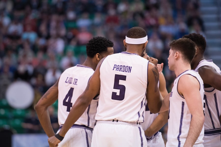 Dererk Pardon and the Wildcats’ starting lineup huddles before an NCAA Tournament game. NU has high expectations for next season.