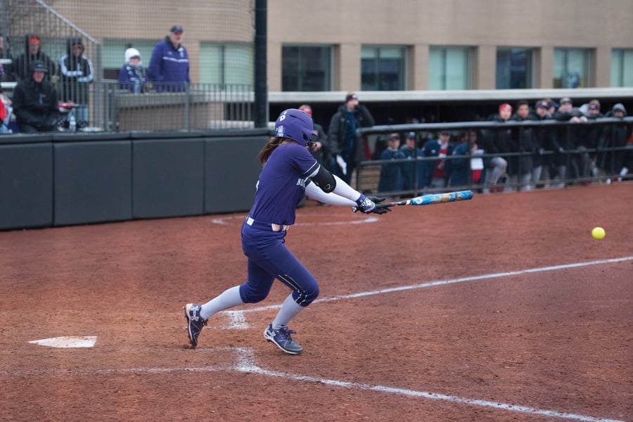 Sabrina Rabin slaps at the ball. The junior outfielder and the Wildcats head to Iowa this weekend to conclude the regular season.