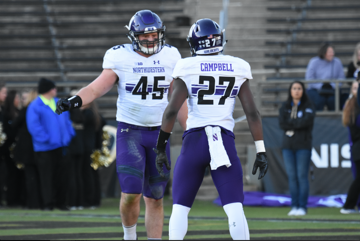 Nathan Fox (left) celebrates with a teammate in a game last year. Fox is a candidate to take over the middle linebacker job this season, though coach Pat Fitzgerald said there may not be a determined starter at that position.