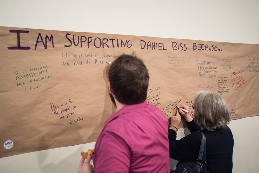 Locals write statements of support in the Biss for Illinois Evanston Field Office. Volunteers said most Evanston residents maintain support for State Sen. Daniel Biss (D-Evanston) despite controversy over his split with former running mate Chicago Ald. Carlos Ramirez-Rosa (35th). 

