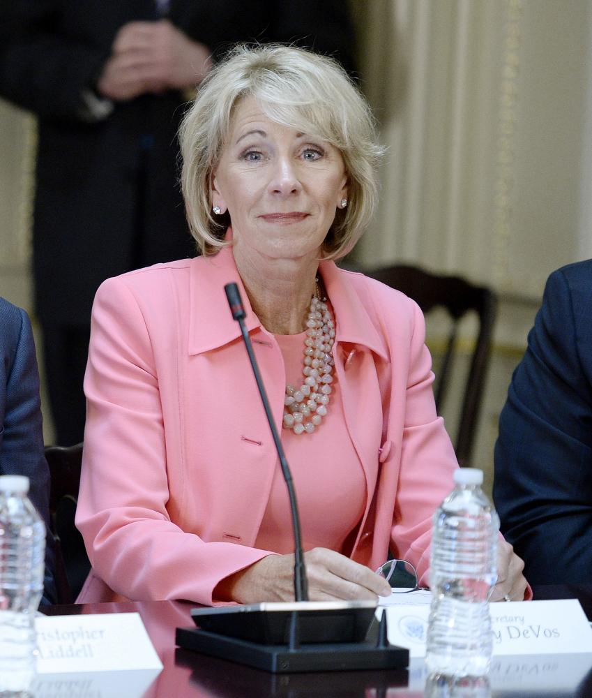 Education Secretary Betsy DeVos listens to a speech earlier this year. DeVos on Friday announced that she would roll back Obama-era guidelines on sexual assault.