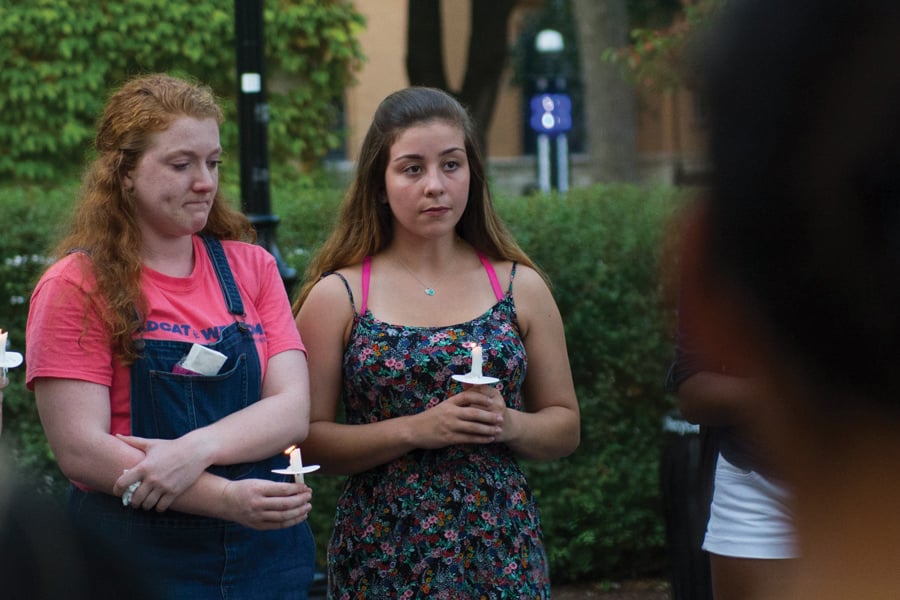 Katharine Cusick (left) stands at the Rock with other NU students at the vigil on Friday. The vigil was held to honor Chuyuan “Chu” Qiu, who died a year ago in a bike accident on Sheridan road.