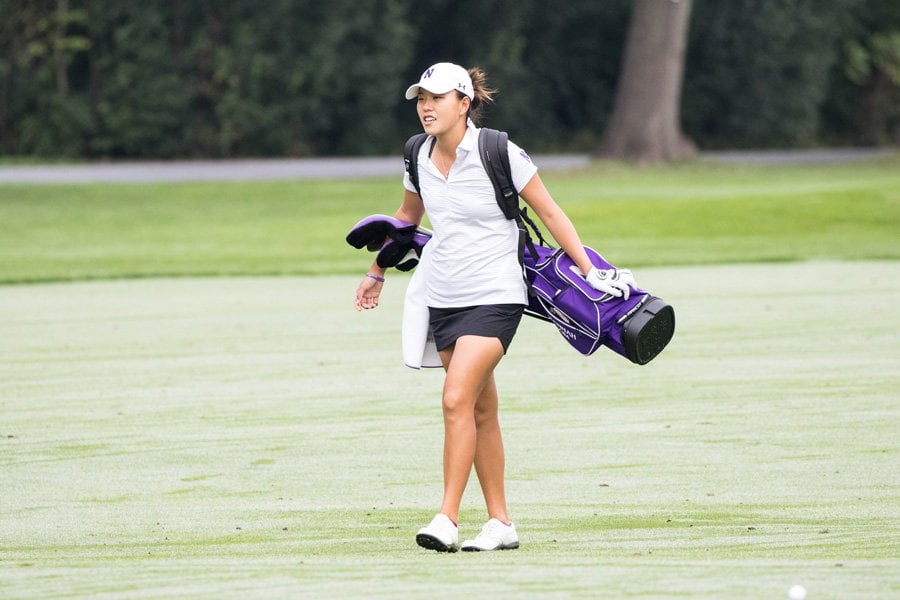 Hannah Kim walks with her clubs. The senior helped lead the Wildcats to a second-place finish at the Dick McGuire Invitational.