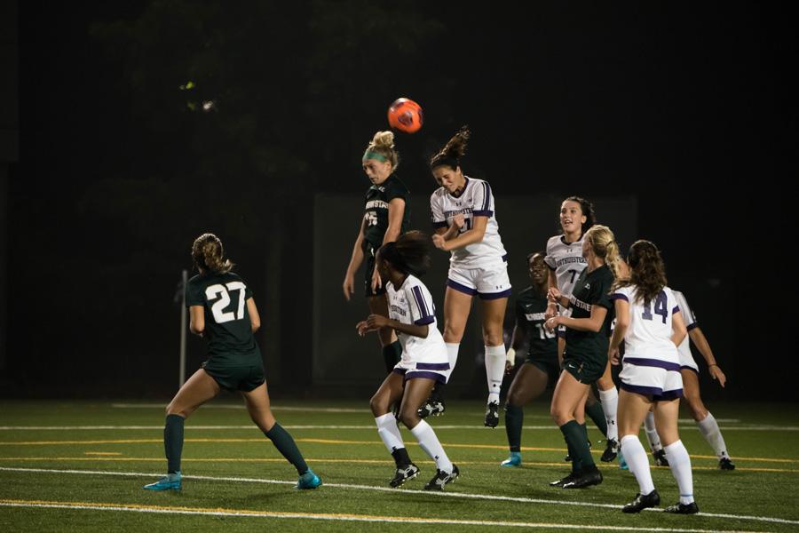 Kayla Sharples heads a ball away. The junior defender and the Wildcats dropped their Big Ten opener at Penn State.