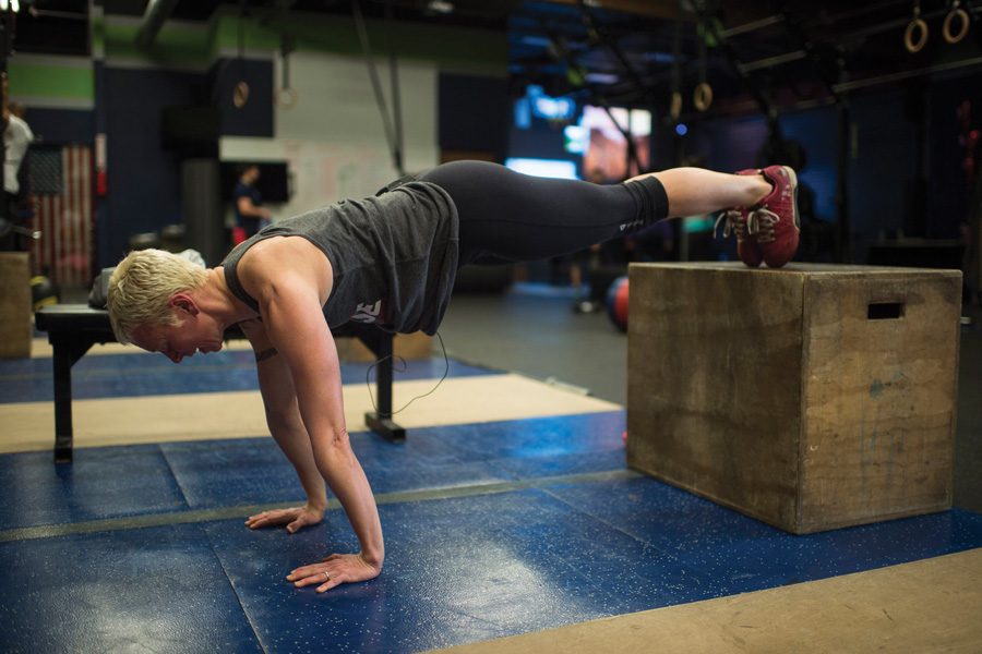 A CrossFit trainer demonstrates decline pushups. Owner Tani Mintz said her new studio, Sharp Edge CrossFit, will have its grand opening on Sunday. 