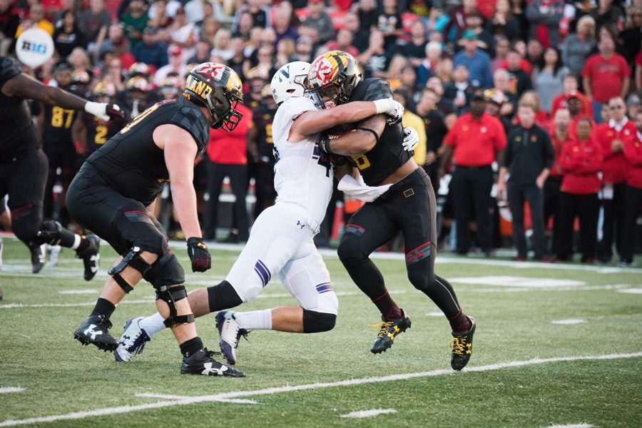 Paddy Fisher tackles a Maryland player in Northwestern’s game against the Terrapins earlier this month. The redshirt freshman linebacker has stepped up this season.