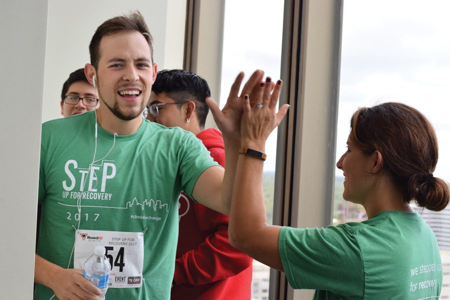A Step Up for Recovery participant reaches the finish line on Bank One tower’s 20th story. More than 200 community members engaged in the event, organized by PEER Services, to raise funds for substance abuse treatment. 
