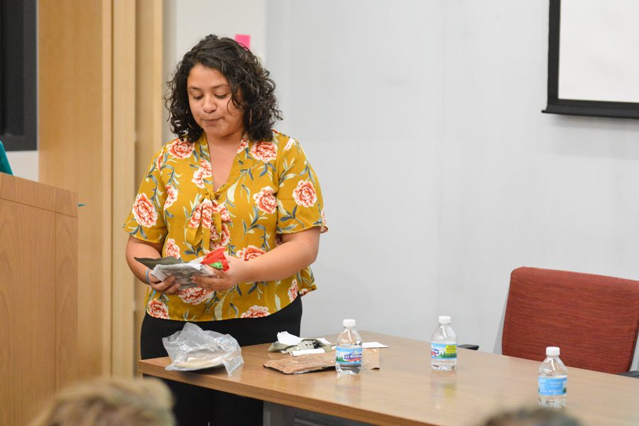 Second-year graduate student Zorimar Rivera Montes shows students samples of government-provided food from Puerto Rico. Rivera Montes co-led a teach-in Tuesday focusing on the history of Puerto Rico and the effects of Hurricane Maria. 