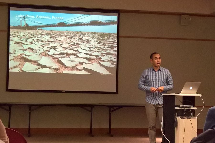 Drew Solomon speaks at an Evanston Public Library event. He discussed climate change and the need for grassroots activism.