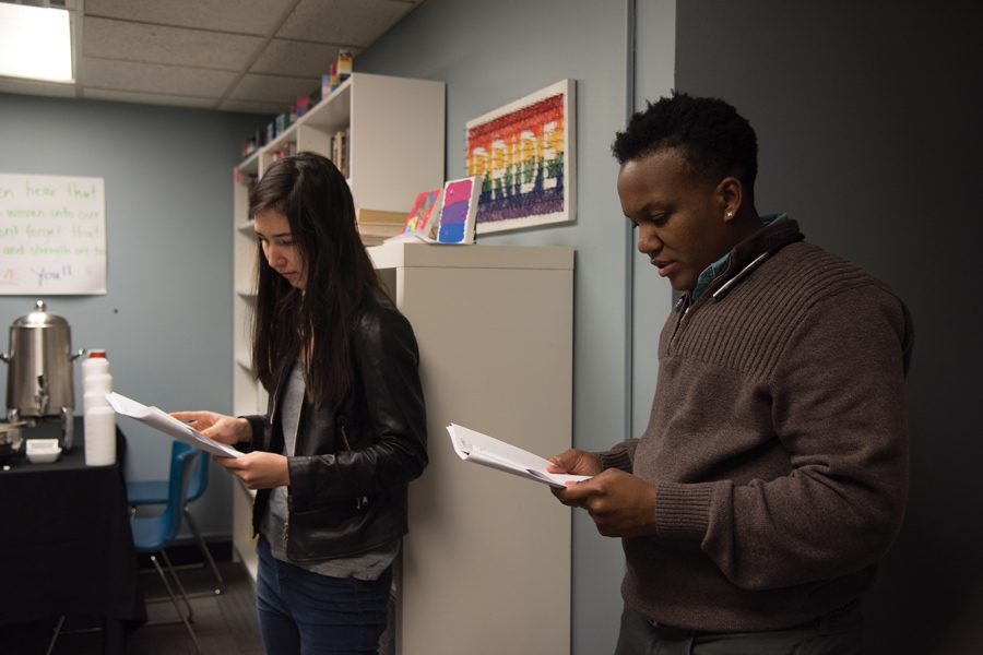 Sylvia Regan (left) and JT Turner read the names of victims of anti-transgender violence during a vigil in the Gender and Sexuality Resource Center. The event was held by Multicultural Student Affairs Monday in observance of Transgender Day of Remembrance.    
