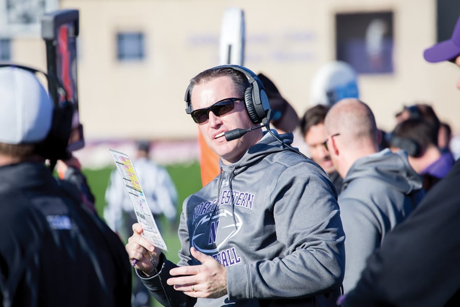 Pat+Fitzgerald+has+a+conversation+on+the+sideline.+Lou+Ayeni+is+the+newest+addition+to+Fitzgerald%E2%80%99s+staff+and+is+set+to+serve+as+running+backs+coach.