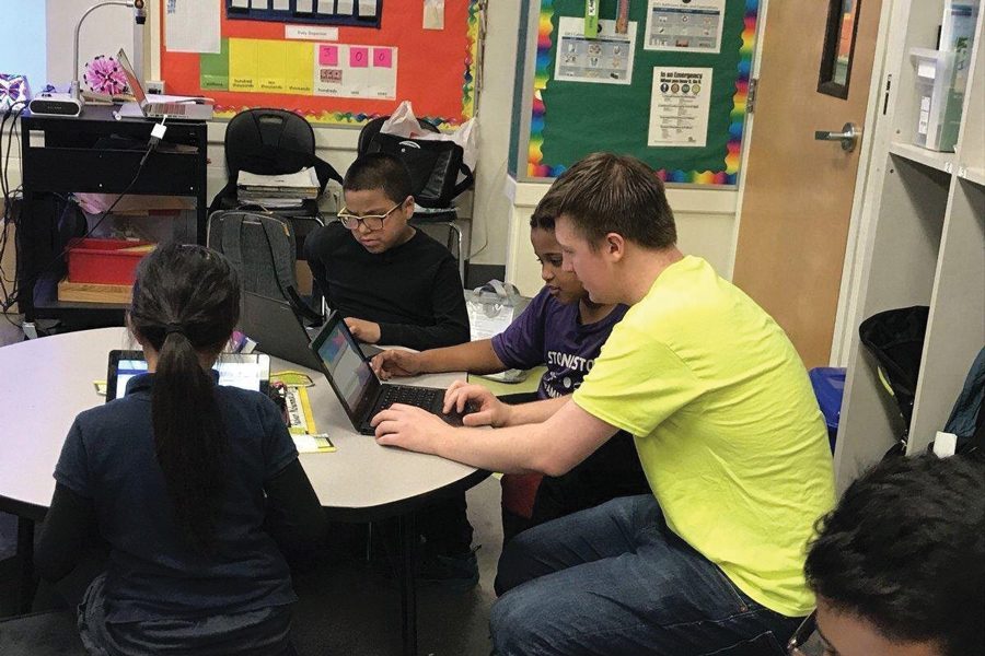 McCormick junior and Codemoji co-founder Livio Bolzon helps a student with a Codemoji lesson in a San Francisco school. Codemoji and HotPlate, two student-owned Northwestern startups, were chosen as semi-finalists in a national startup competition.