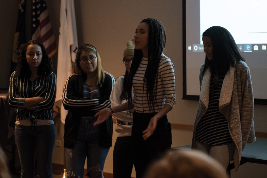 Five Evanston Township High School students present at Evanston Public Library. The students displayed their “photovoice” projects — where photos are hung beside captions expressing the artist’s intent.